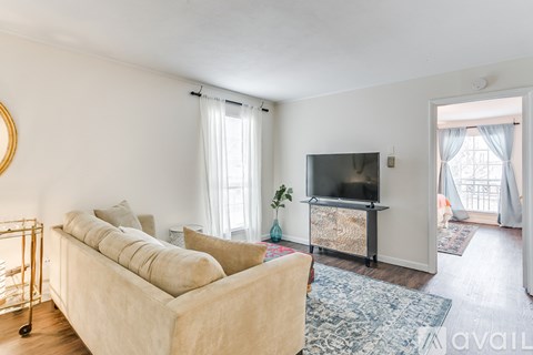 A living room with a beige sofa and a television.