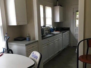 A kitchen with a table and chairs in it.