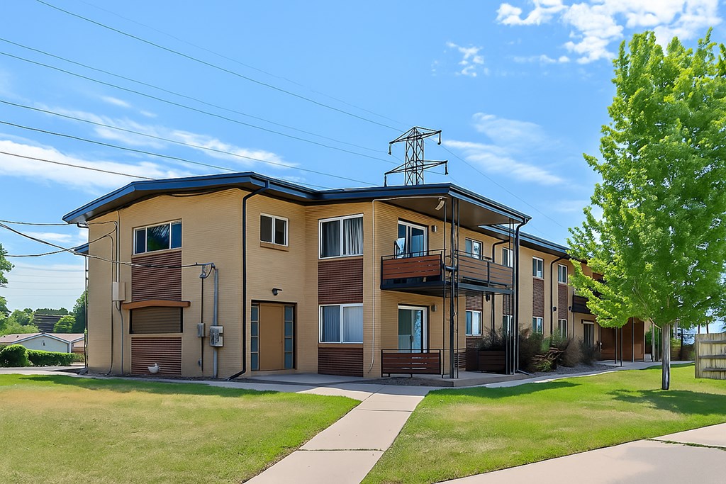 A row of houses with a tree in front of the first house.