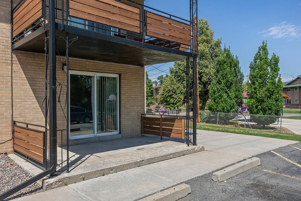 A modern building with a balcony and a glass door.
