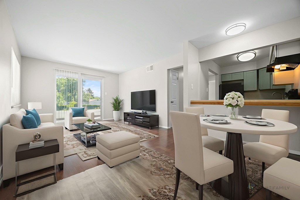A modern living room with a white sofa, a white armchair, a white coffee table, and a white dining table.