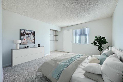 A bedroom with a large bed and a painting on the wall.
