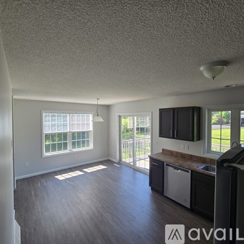 A kitchen area with a dishwasher and a microwave.