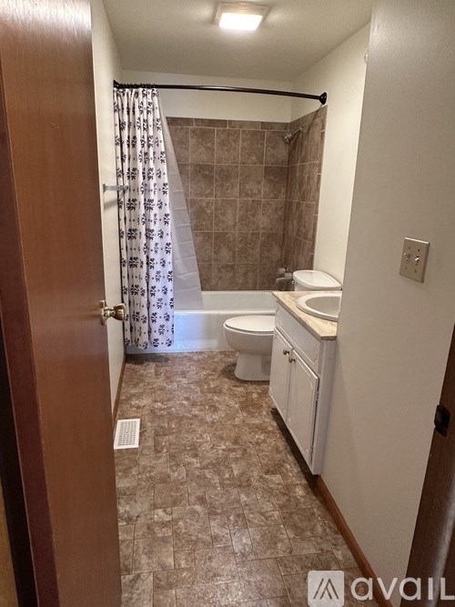 A bathroom with a toilet, sink, and shower.