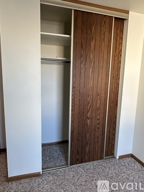 A white door is open to a room with a wooden door.