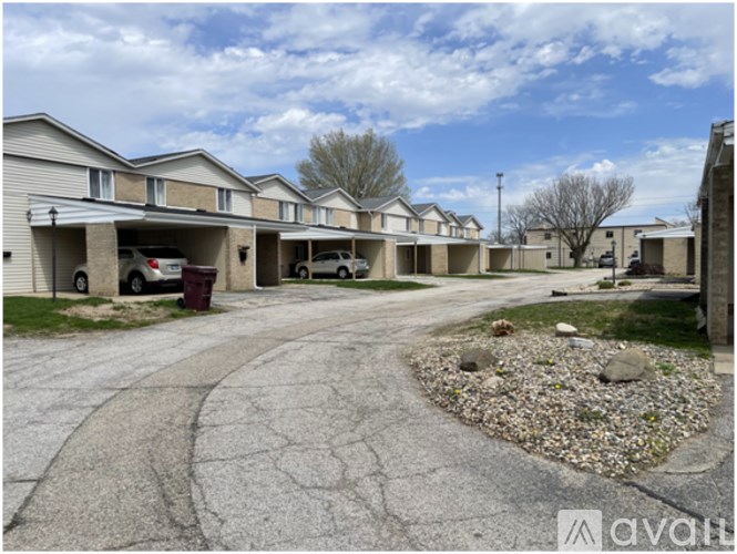 A row of houses with a driveway in front.