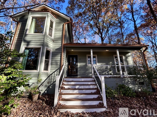 A house with a porch and a front yard.