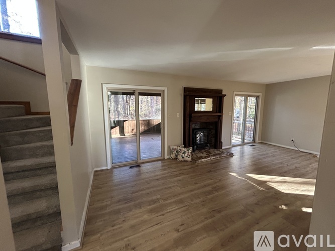 A living room with a fireplace and sliding glass doors.