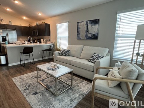 A modern living room with a white sofa and a coffee table.