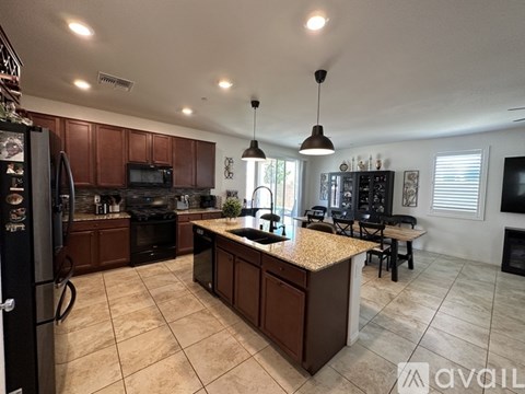 A kitchen with brown cabinets and a granite countertop.