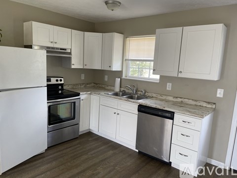 A kitchen with white cabinets and stainless steel appliances.