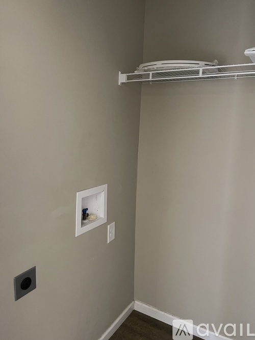 A white shelf with plates on it in a room.