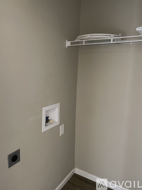 A white shelf with plates on it in a room.