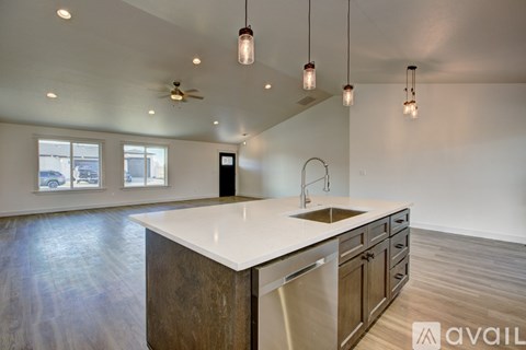 A kitchen with a white counter top and wooden cabinets.