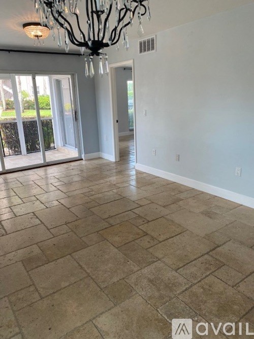 A room with a tiled floor and a chandelier.