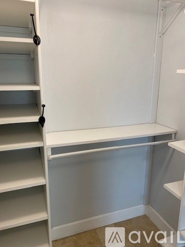 Empty white shelves in a room.