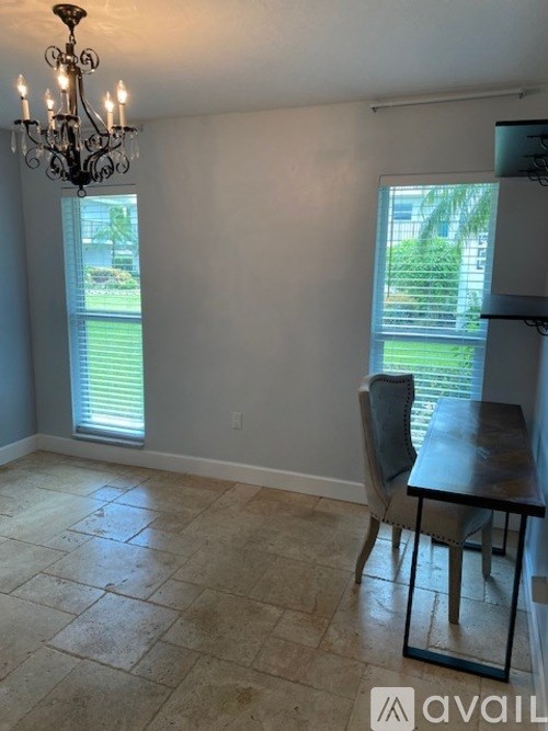 A dining room with a table and chairs.