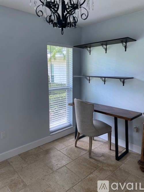 A dining room with a table and chairs.