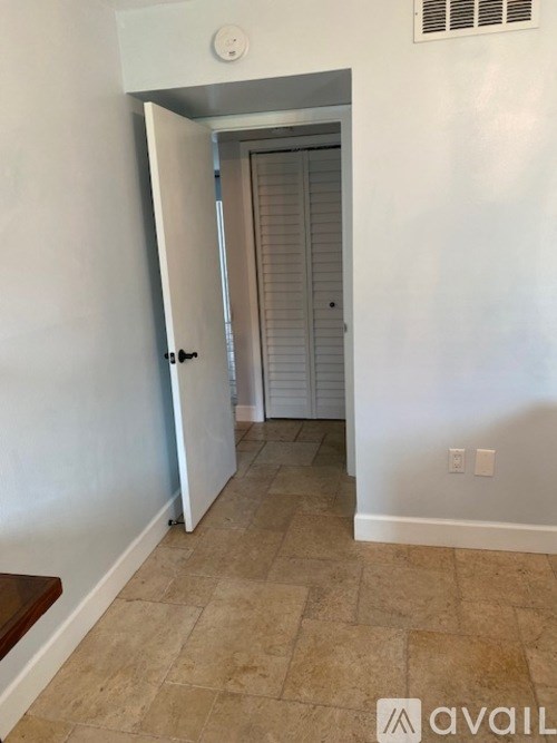 A hallway with a door at the end.