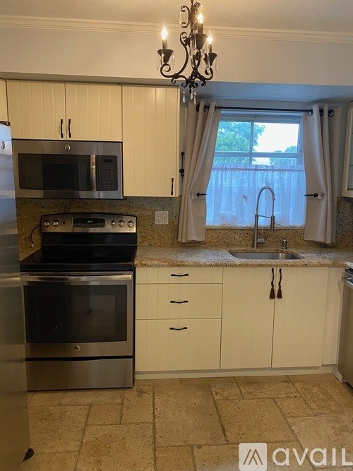 A kitchen with a stove top oven and microwave.