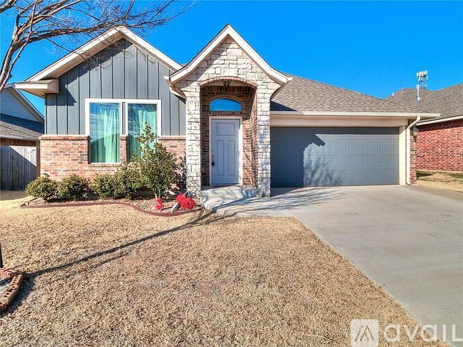 A house with a grey roof and a white door is for sale.