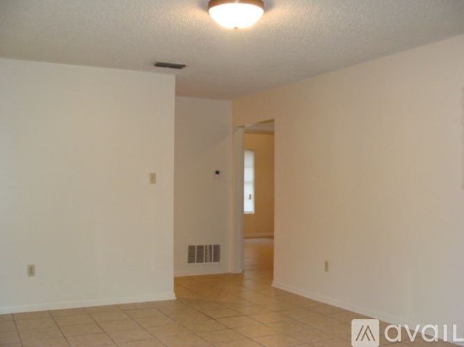 A room with a white wall and a door.