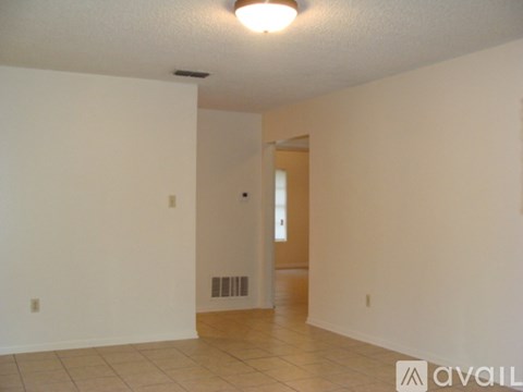 A room with a white wall and a door.
