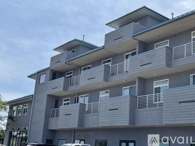 A modern multi-story building with the word "AVAILABLE" on the front.
