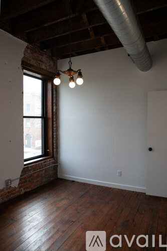 A room with wooden floors and a window.