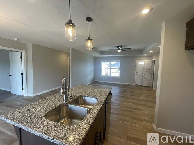 A kitchen with granite countertops and a sink.