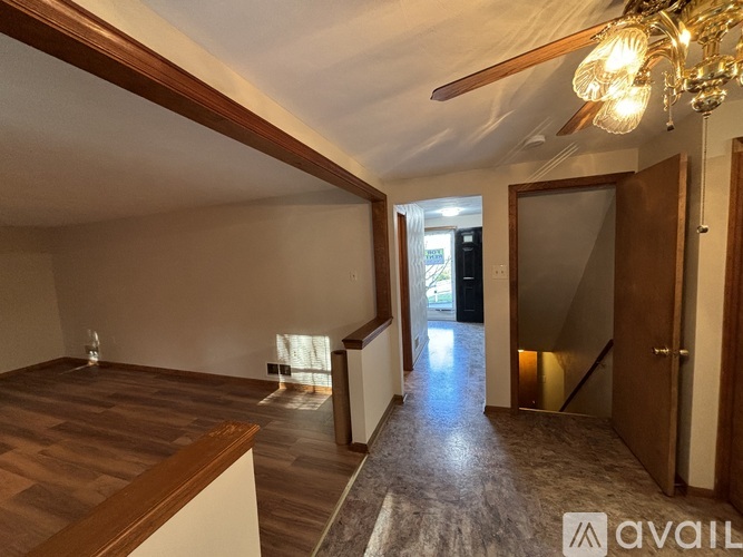 A room with wooden floors and a chandelier.