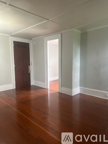 A room with wooden floors and white walls.