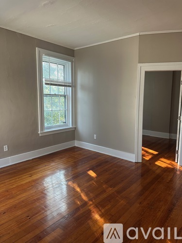 A room with wooden floors and a window.