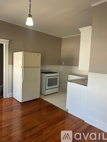 A kitchen with a white fridge and a white counter.