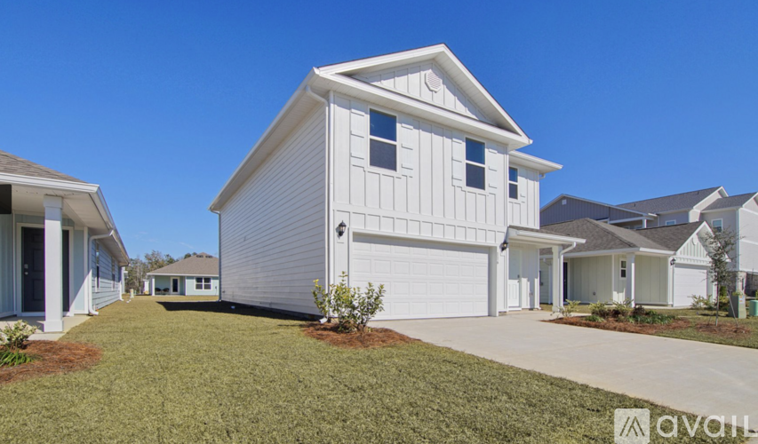 A white house with a garage is for sale.