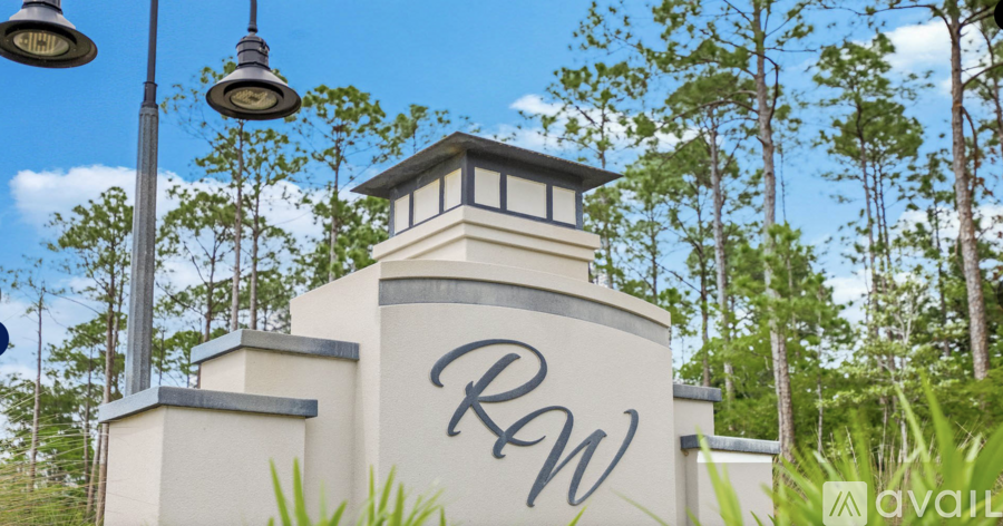 A building with the letters "RW" on it is surrounded by trees.