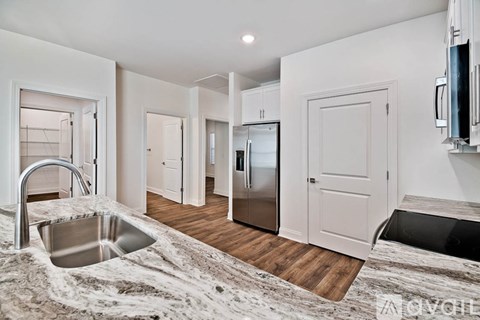 A modern kitchen with a sink and a refrigerator.