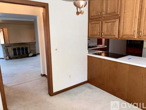 A kitchen with wooden cabinets and a white countertop.