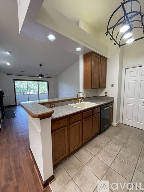 A kitchen with wooden cabinets and a white countertop.