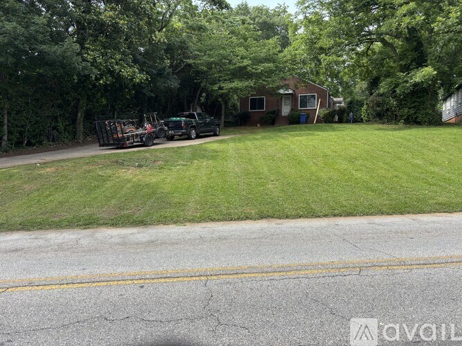 A black truck is parked in a driveway next to a house.