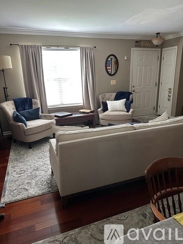A living room with a sofa, chair, and table.