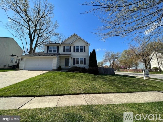 A house with a lawn in front of it.