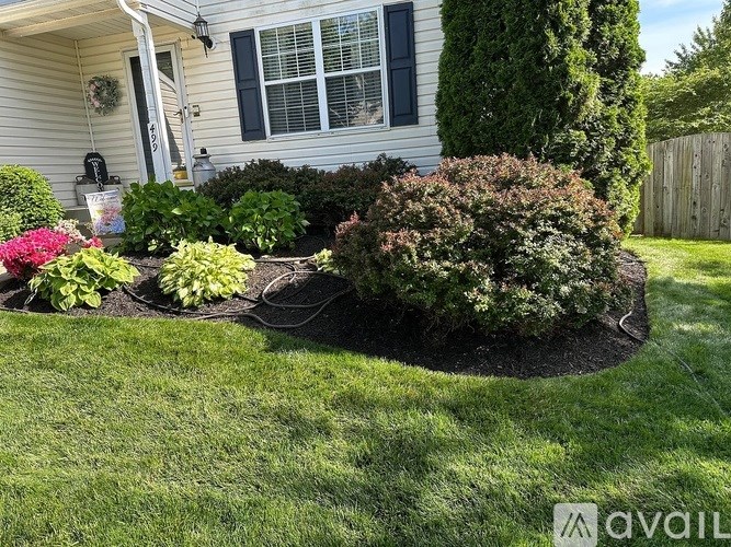 A well-maintained garden in front of a house.