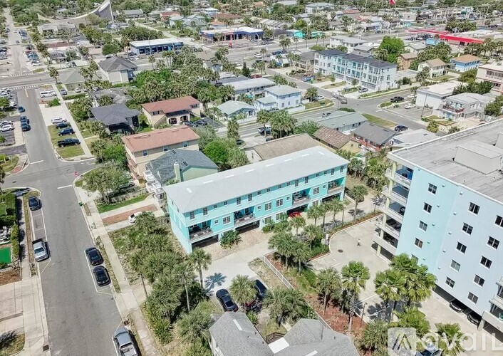 A bird's eye view of a street with cars and buildings.