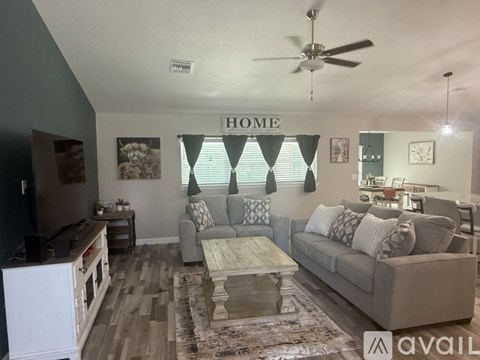 A living room with a grey couch and a coffee table.