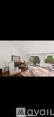 A living room with a rug and a couch.