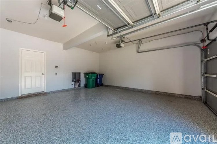A spacious garage with a concrete floor and white walls.