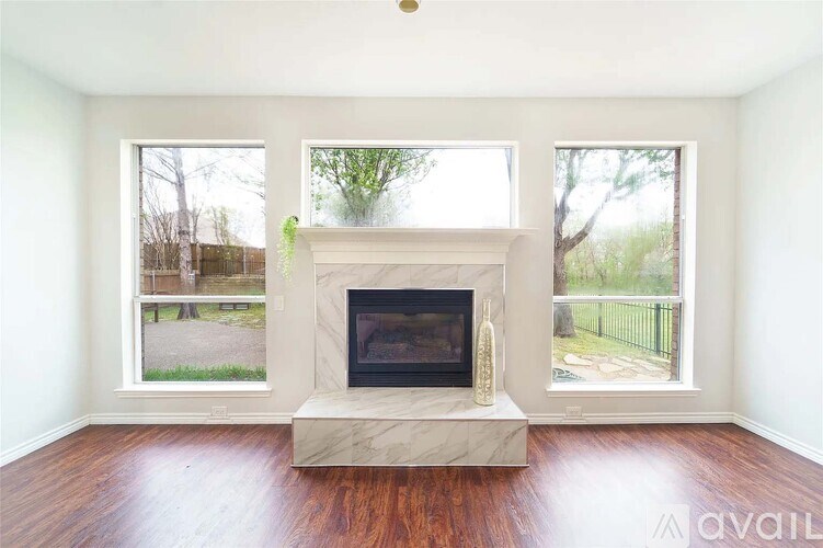 A living room with a fireplace and a vase on top of it.