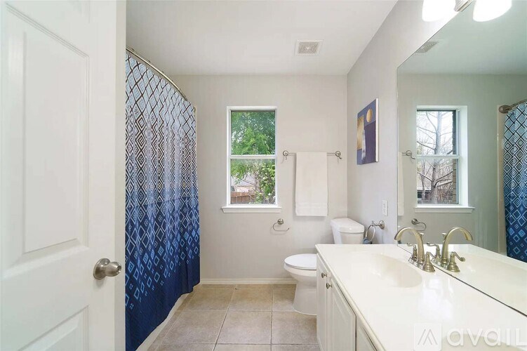 A bathroom with a toilet, sink, and shower.