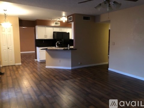 A kitchen with brown cabinets and a black countertop.